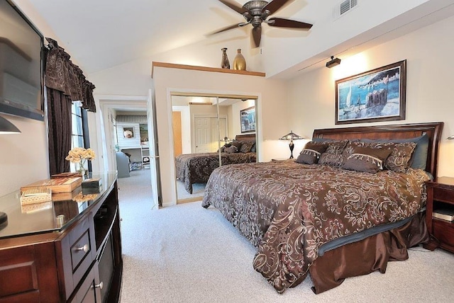 bedroom with visible vents, carpet, vaulted ceiling, a closet, and a ceiling fan