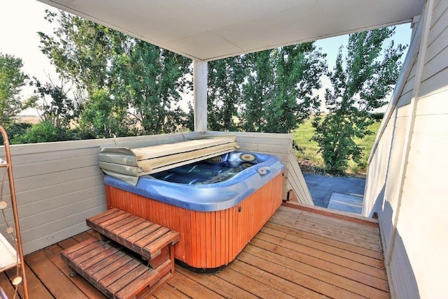 wooden deck with a hot tub