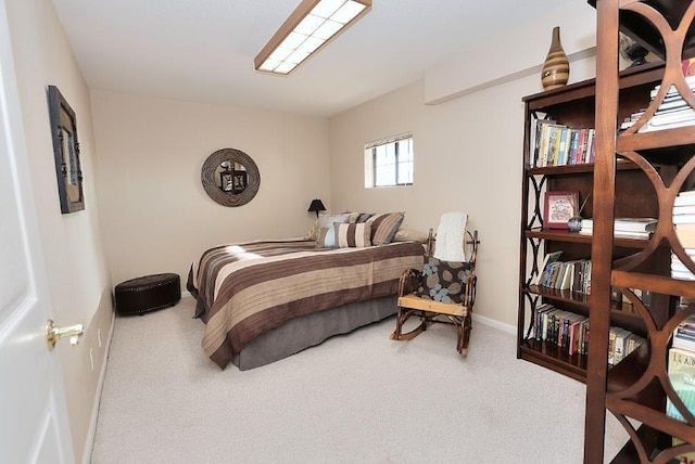 bedroom featuring carpet and baseboards