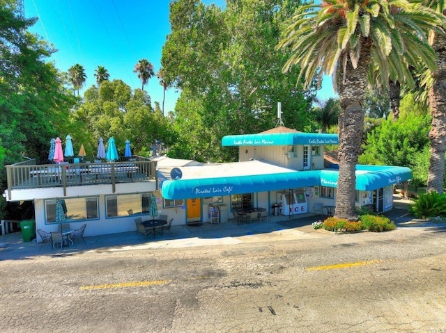 view of building exterior with uncovered parking