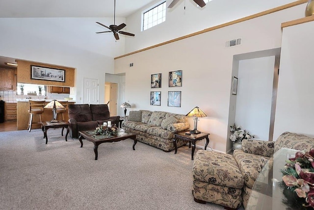 carpeted living area with visible vents and ceiling fan