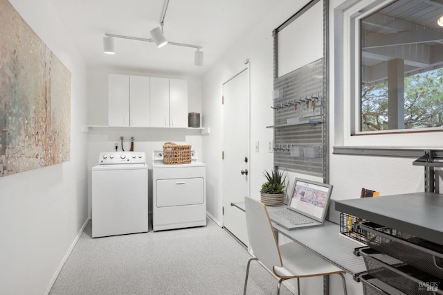 laundry room with baseboards, cabinet space, rail lighting, and washing machine and clothes dryer