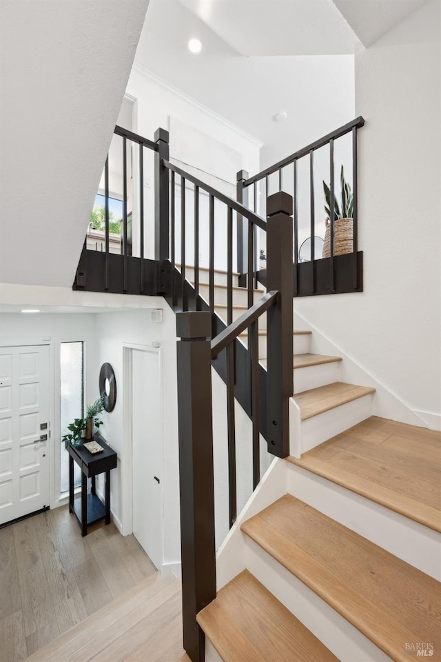 staircase featuring recessed lighting and wood finished floors