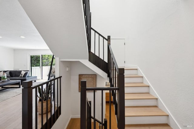 stairs featuring recessed lighting, baseboards, and wood finished floors