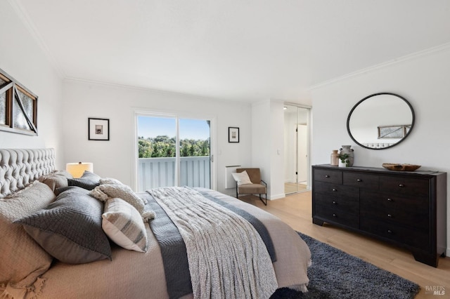 bedroom featuring access to exterior, light wood-style floors, and ornamental molding