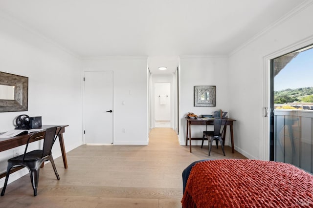 bedroom with baseboards, light wood-style floors, and ornamental molding