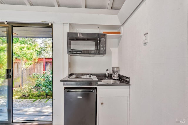 kitchen featuring open shelves, a sink, white cabinets, black microwave, and dark countertops