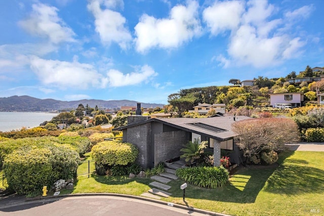 exterior space featuring a water and mountain view