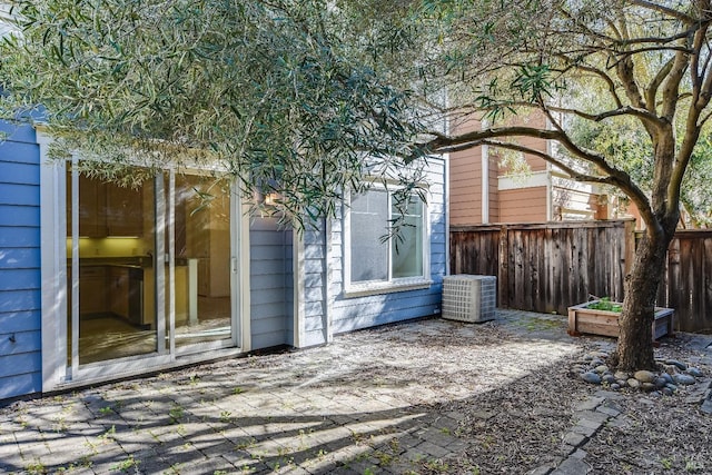view of patio featuring fence and central air condition unit