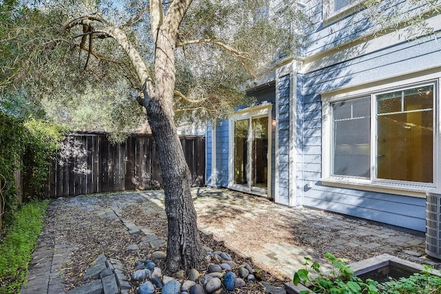 view of home's exterior with a patio and fence