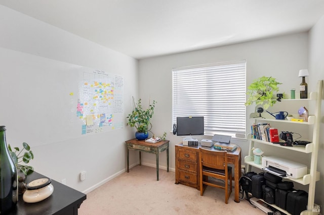 carpeted office space featuring baseboards