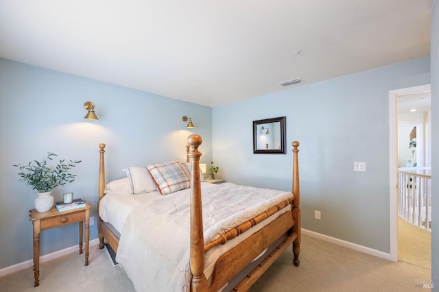 bedroom featuring visible vents, baseboards, and light colored carpet