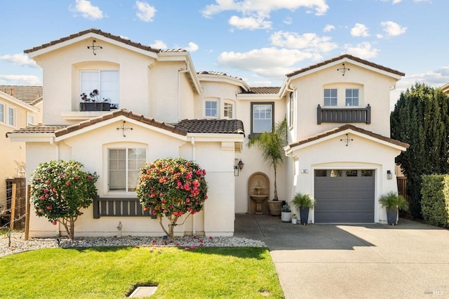 mediterranean / spanish house featuring stucco siding, driveway, a front yard, a garage, and a tiled roof