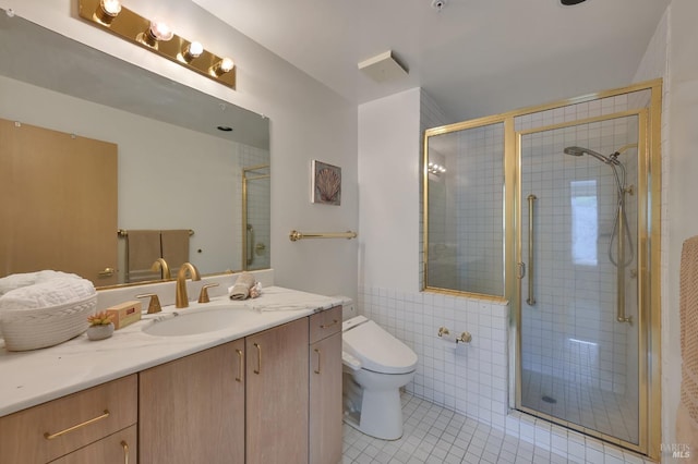 bathroom with tile walls, toilet, a stall shower, tile patterned floors, and vanity