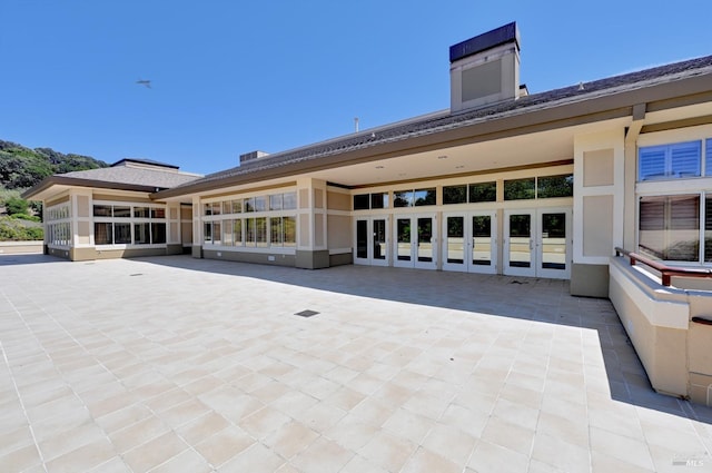 exterior space featuring stucco siding, french doors, and a patio area