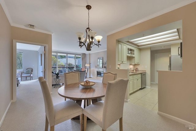 dining space featuring baseboards, light colored carpet, an inviting chandelier, and ornamental molding