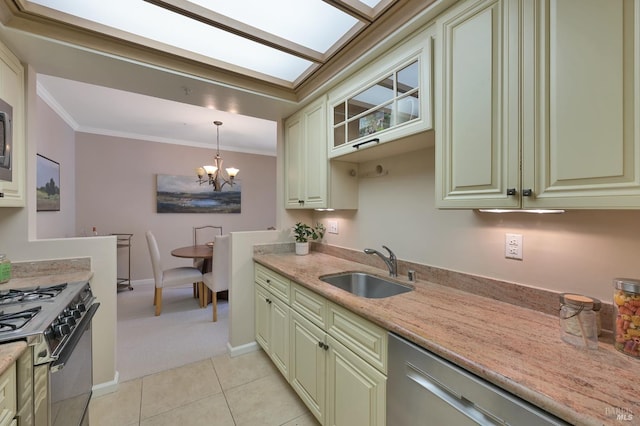 kitchen featuring light tile patterned flooring, ornamental molding, a sink, gas range oven, and green cabinets