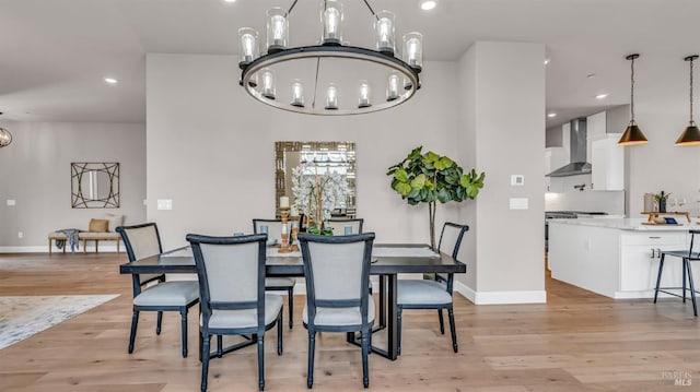 dining area featuring recessed lighting, baseboards, a notable chandelier, and light wood finished floors