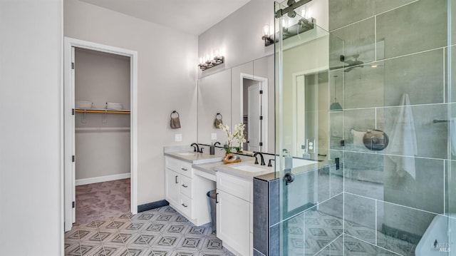 full bath with baseboards, vanity, a spacious closet, and a shower stall