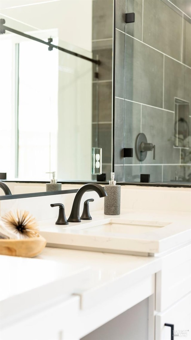 full bath featuring vanity and a shower stall