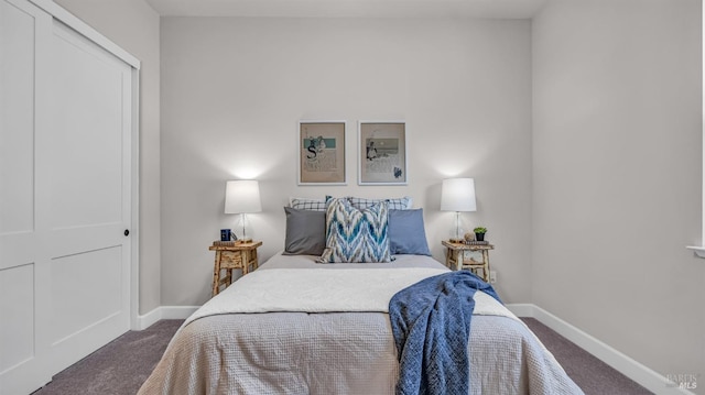 bedroom featuring baseboards and dark carpet