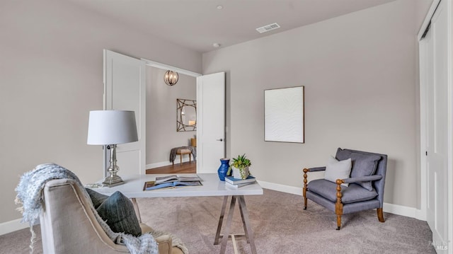 carpeted office space with visible vents and baseboards