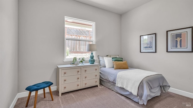 carpeted bedroom featuring baseboards