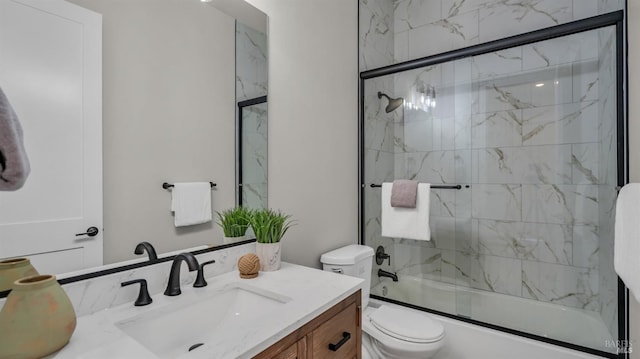 full bathroom featuring bath / shower combo with glass door, vanity, and toilet