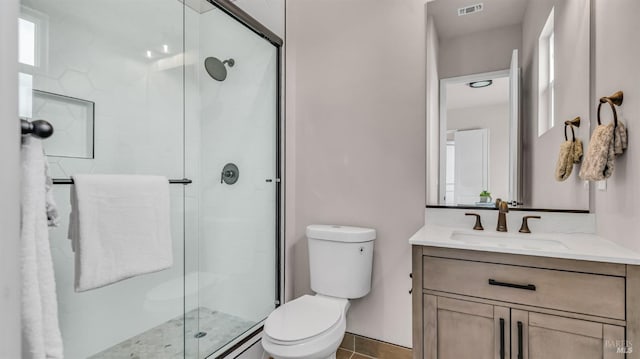 full bath featuring visible vents, vanity, toilet, and a shower stall