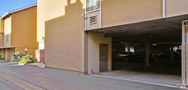 entrance to property with stucco siding