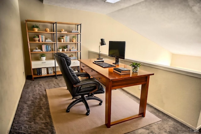 carpeted home office featuring lofted ceiling