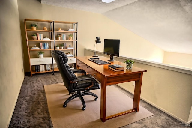 carpeted office with vaulted ceiling