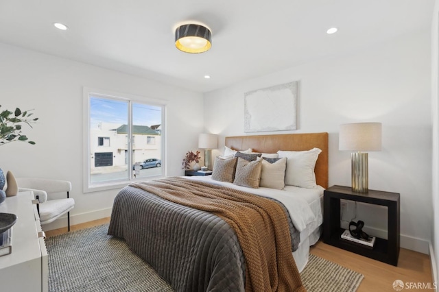 bedroom with recessed lighting, baseboards, and light wood-style flooring