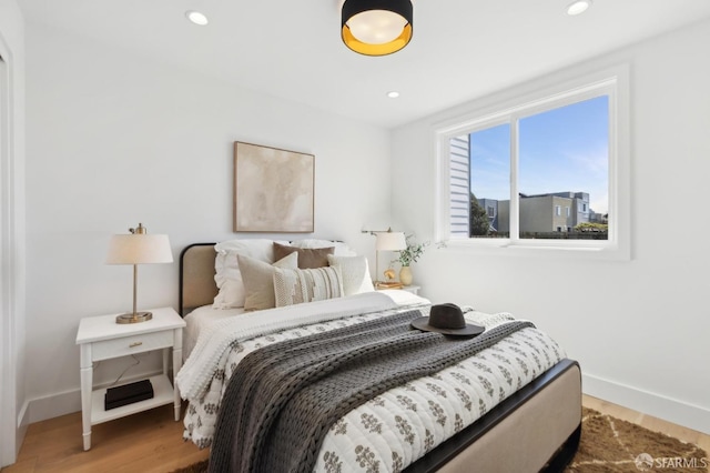 bedroom featuring recessed lighting, baseboards, and light wood-style floors