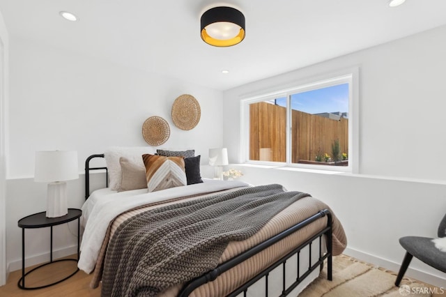 bedroom with recessed lighting, baseboards, and wood finished floors