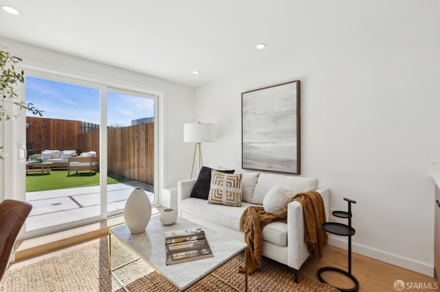 living area featuring wood finished floors, recessed lighting, and baseboards