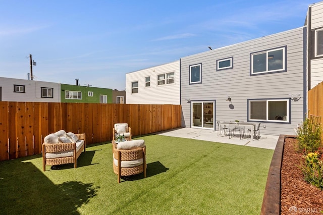 back of property with a yard, a patio, and a fenced backyard