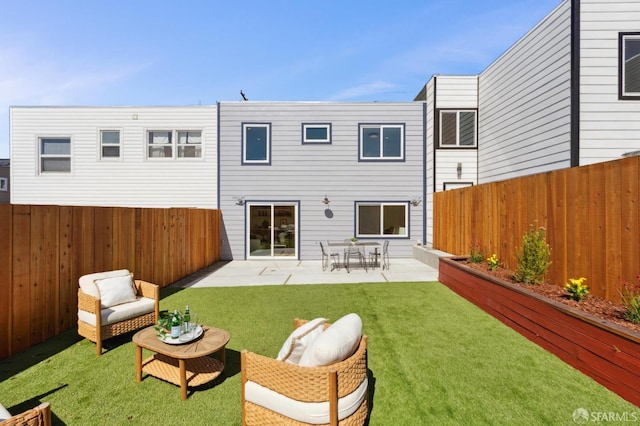 back of house featuring a patio area, a yard, and a fenced backyard