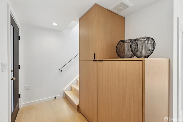 interior space with visible vents, light wood-style flooring, recessed lighting, baseboards, and stairs