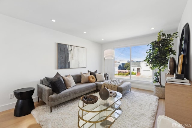 living room featuring recessed lighting, baseboards, and wood finished floors