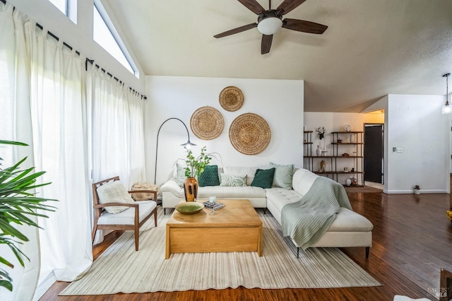 living area featuring baseboards, high vaulted ceiling, ceiling fan, and wood finished floors