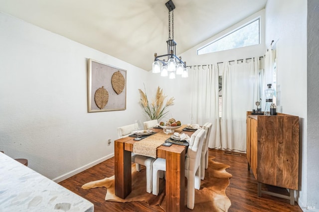 dining room with dark wood-type flooring, baseboards, and vaulted ceiling