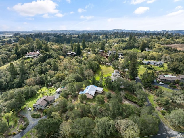 birds eye view of property featuring a view of trees