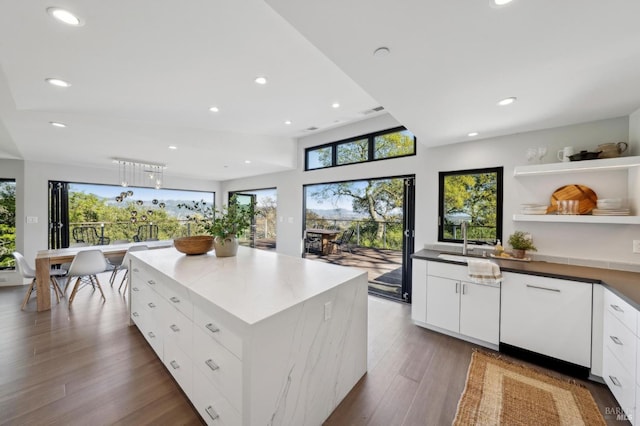 kitchen with open shelves, a kitchen island, wood finished floors, recessed lighting, and white cabinets