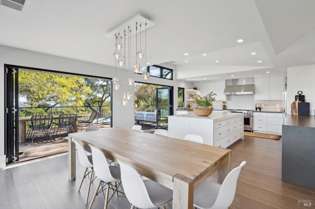 dining space featuring recessed lighting, visible vents, and wood finished floors