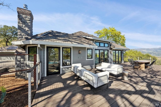 wooden deck featuring an outdoor hangout area, outdoor dining area, and french doors