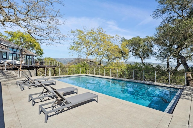 view of swimming pool featuring a fenced in pool, a patio, and fence