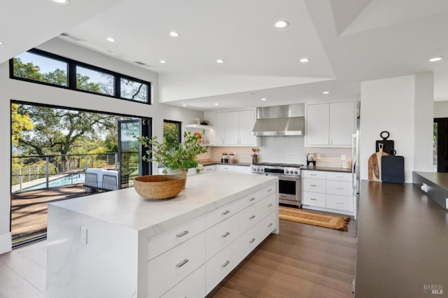 kitchen with open shelves, modern cabinets, wall chimney exhaust hood, and stainless steel range