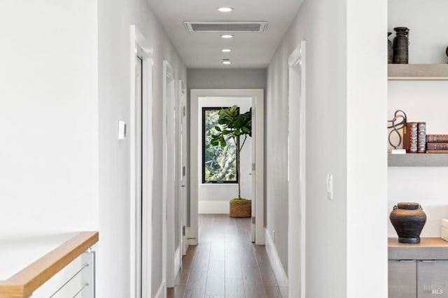 corridor featuring recessed lighting, visible vents, baseboards, and wood finished floors