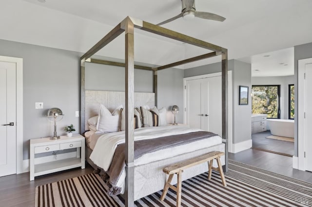 bedroom with ensuite bath and wood finished floors